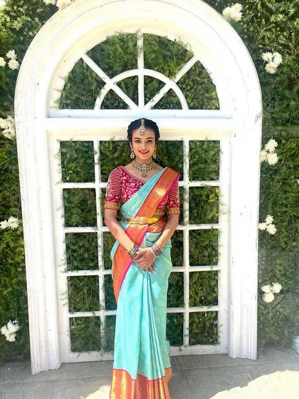Another beautiful shot of the same look, showing how the makeup enhances her features and gives her a polished, celebratory appearance.