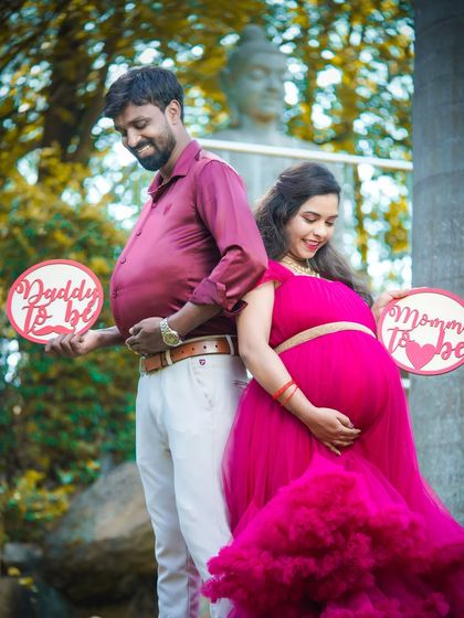 A playful take on the maternity shoot. The dad-to-be joins in on the fun by showing off his own "bump," making for a hilarious and memorable photo.