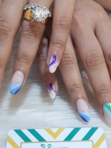 I created this colorful abstract look with wavy lines in pastel shades of orange, green, blue, and purple. The negative space design keeps it feeling light and modern.