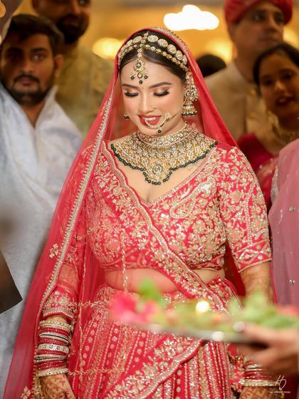 A beautiful candid shot during the wedding rituals. The makeup is designed to be long-lasting and photogenic, looking flawless even in close-up shots throughout the long day.