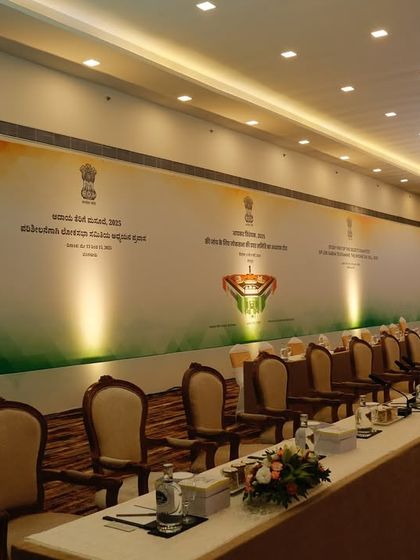 A long shot of the conference seating arrangement, showcasing the clean, extensive backdrop we created. We ensure consistent branding across the entire length of the venue for a polished look.