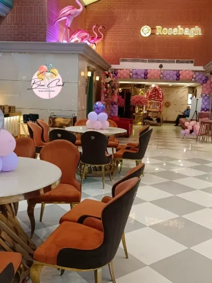 An overview of a restaurant decorated for a party, with balloon centerpieces on each table.