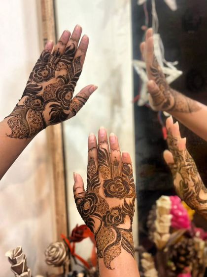 A creative shot using a mirror to reflect the bold rose design, showing it from multiple angles.