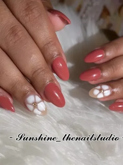 A simple and pretty set with dusty rose nails and a white flower accent.
