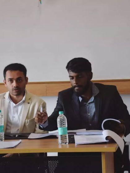 In this photo, I am actively engaged in my role as a moot court judge, listening intently to the arguments being presented by the student advocates.