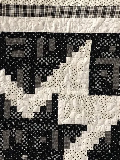 A detail shot of the Log Cabin Star, showing the different printed fabrics used.