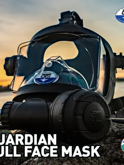 This OTS Guardian Full-Face Mask is shown ready for action at sunset. It features an integrated communications port and an ambient breathing valve, demonstrating its readiness for professional use where clear underwater contact is essential.