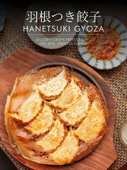 An artistic shot of our Hanetsuki Gyoza, highlighting the crispy "wings" that connect the dumplings. It's a dish that is as texturally interesting as it is delicious.