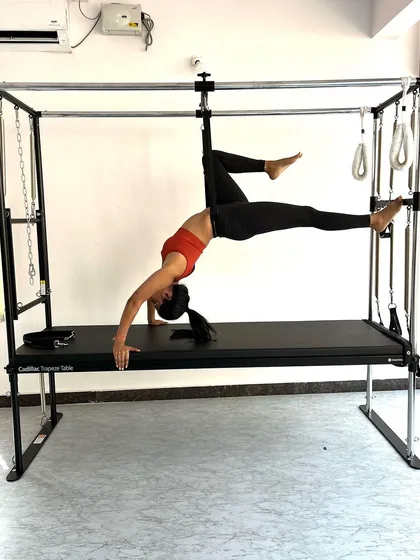 Another angle of the suspended bridge, showing the engagement of the glutes and hamstrings to maintain the pose.