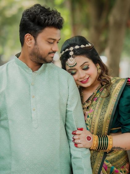 A tender moment where the bride rests her head on the groom's shoulder. This portrait captures the comfort and love they share, highlighted by their beautiful traditional outfits.