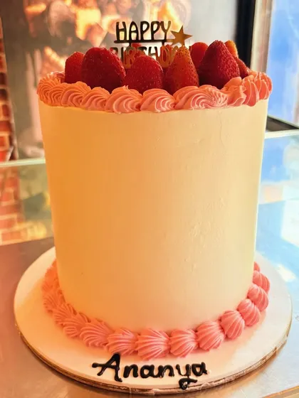 A tall and elegant strawberry cake, topped with fresh strawberries for a simple and classic look.