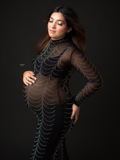 A serene and graceful pose in the stunning spiderweb gown. This shot captures a quiet moment of reflection amidst all the glam.