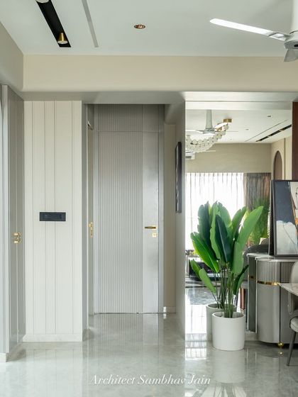 Framing calm in transit. This thoughtfully styled passageway turns a transitional space into a visual pause. A sleek mirror adds depth and light, while potted greens bring a refreshing burst of life.
