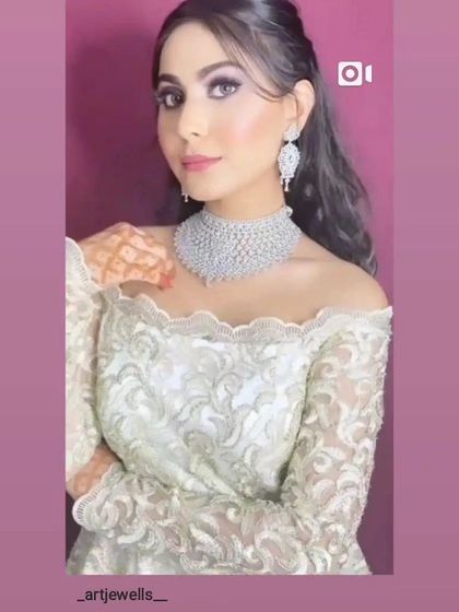 A model wearing an off-shoulder gown with a simple, elegant diamond choker. This is a classic look for any formal event.