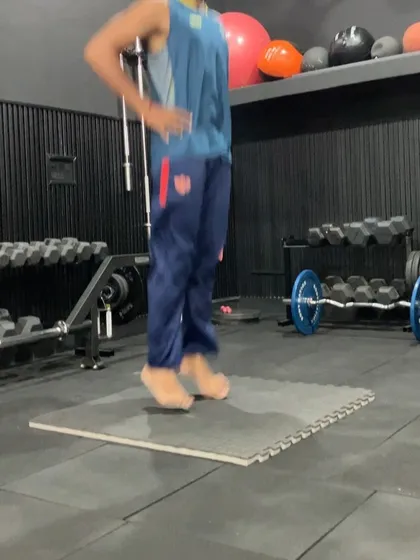 An athlete performing barefoot pogo jumps. This drill strengthens the ankles and calves while improving the elastic properties of the tendons, contributing to more efficient and explosive movements.