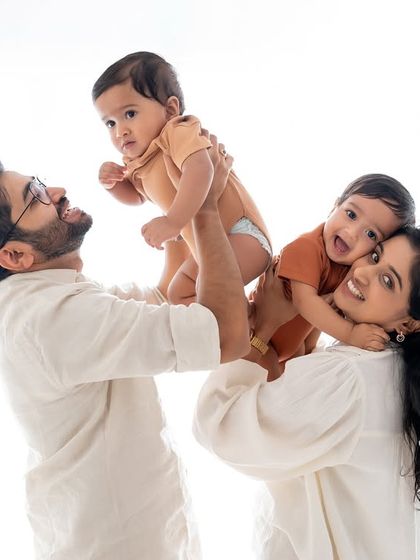 A bright and happy family portrait with twin babies.