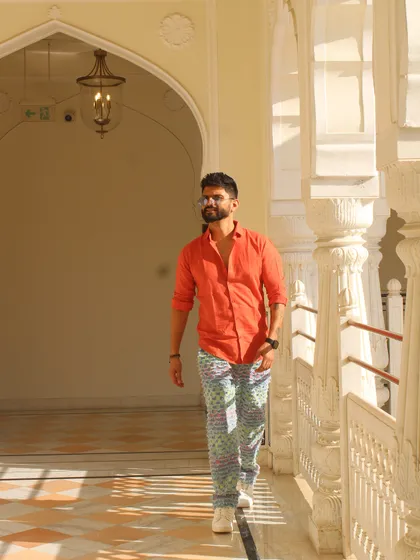 A 'red flag' slay mood in a bright orange shirt and printed pants. This look is all about making a statement.