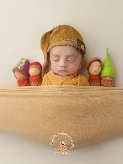 This setup with little gnomes is so whimsical and fun. It's a great way to add a touch of storytelling and personality to your newborn's photos.
