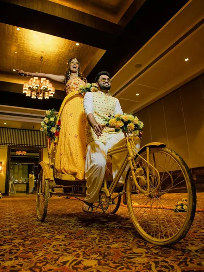 A wide shot of the couple's fun rickshaw entry, capturing the excitement and energy of the moment.