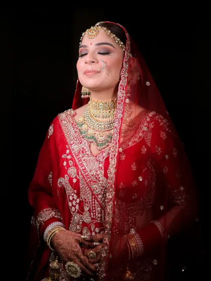 A moment of pure bridal serenity. This close-up shot focuses on the intricate details of the airbrush makeup, from the perfectly blended eyeshadow to the radiant skin finish, creating a look of peaceful elegance before the main ceremony.