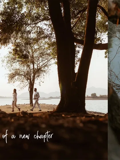 A low-angle shot of a couple walking hand-in-hand by the lake at sunset, capturing the beginning of their new chapter together.