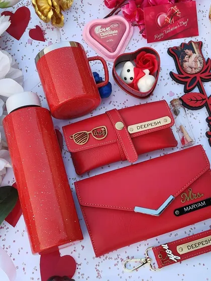 A stunning, all-red Valentine's hamper for her. It includes a sparkle flask and mug, a personalized clutch and eyewear case, a custom photo rose stick, and chocolates.