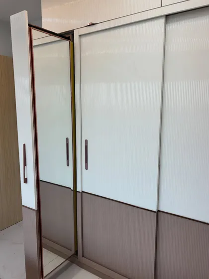 This image shows the slim profile mirror attached to the side of the wardrobe, a clever space-saving trick.