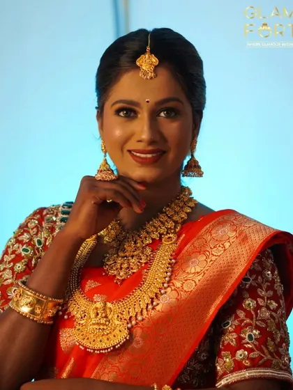 A radiant South Indian bride glowing with happiness. The makeup is set to be flawless both in person and on camera, a key skill we teach for professional artists.