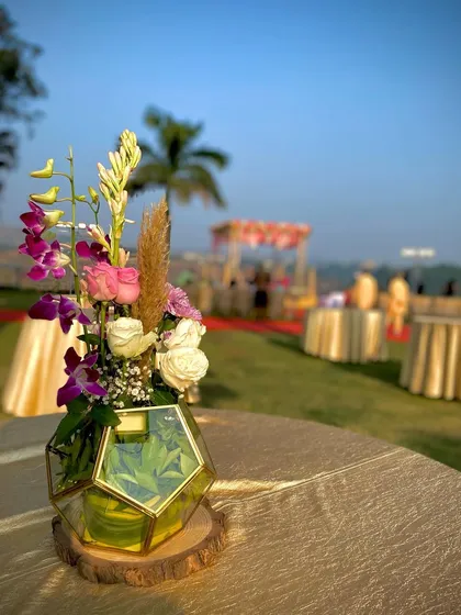 Here is the same modern centerpiece in the daylight. You can clearly see the combination of purple dendrobium orchids, pink and white roses, and tuberose, which works well for both day and night events.
