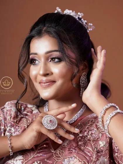 This model is wearing a beautiful AD set with a pink lehenga. The heart-shaped necklace is a unique and romantic choice.