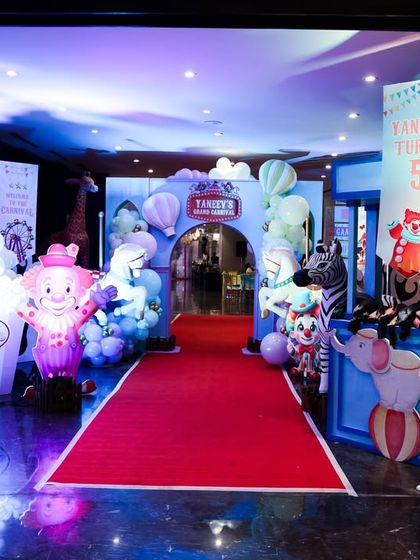 The carnival entrance at night, with dramatic lighting creating an exciting and magical atmosphere.