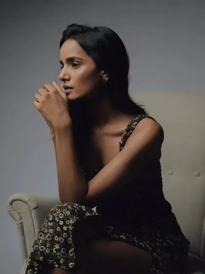 A thoughtful profile pose. The natural makeup and hair styling contribute to the raw and authentic feel of this editorial series.