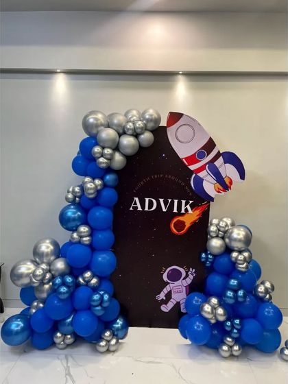 This image highlights the custom backdrop and balloon arrangement for our popular space theme. The metallic silver and deep blue balloons create a cosmic feel, perfect for a young explorer's birthday.