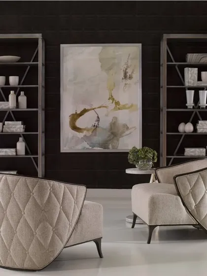 A pair of our winged lounge chairs, creating a perfectly symmetrical and inviting seating arrangement. The dramatic, tufted backs of the chairs serve as a beautiful design element.