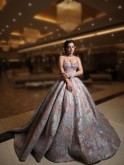 Another shot of the metallic-sheen ball gown, this time with a softer focus, highlighting the dress's texture and the client's elegant pose.