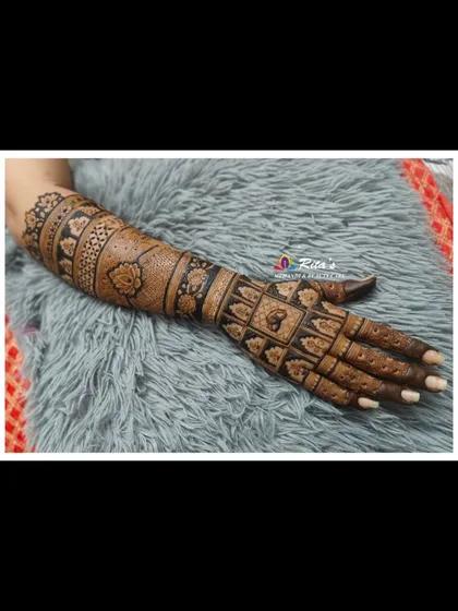 A single arm view, highlighting the different bands of patterns, from floral motifs to checkered designs.