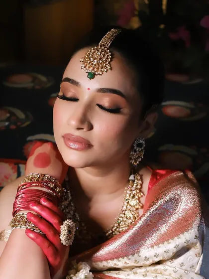 Another artistic shot of the bride, her eyes closed, highlighting the serene beauty of the moment.