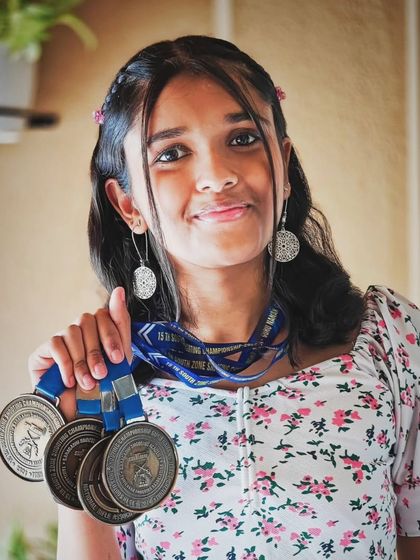 A portrait of our champion, Shika Sajith, with her impressive haul of gold medals from the XV South Zone Air Pistol Shooting Championship. Her dedication is an inspiration to all our athletes.