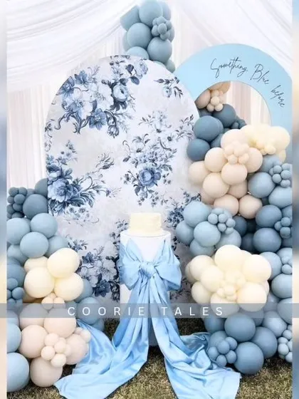 A classic "Something Blue" theme for a sophisticated bridal or baby shower. This design features a beautiful vintage floral print backdrop, satin bows, and a cascade of blue and white balloons for a touch of Parisian elegance.