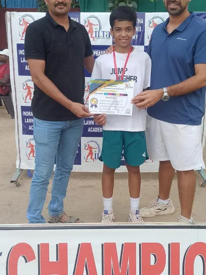 A young player receiving his certificate and medal at our prize money tournament. Every participant is a winner for having the courage to compete.