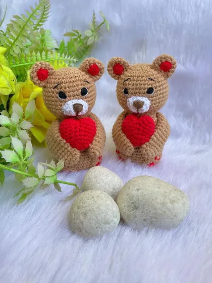 A classic teddy bear, a timeless gift for any age. This one is shown with a red ribbon, a black tie for 'Daddy Bear', and with expressive green eyes. They are soft, cuddly, and made to be loved.