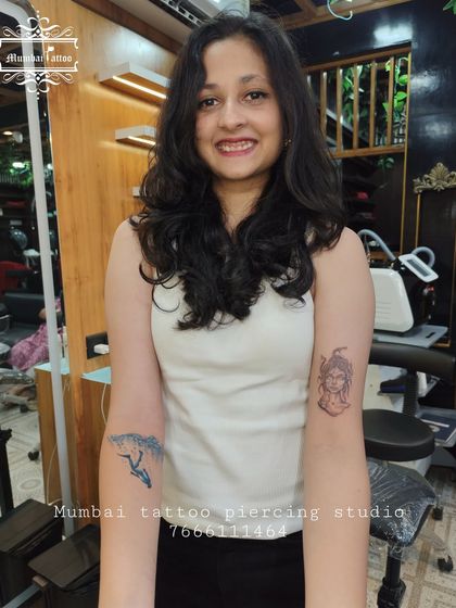 This client got two tattoos in one session: a powerful Medusa head and a dynamic surfing wave. It shows our versatility in handling different styles, from mythology to nature.