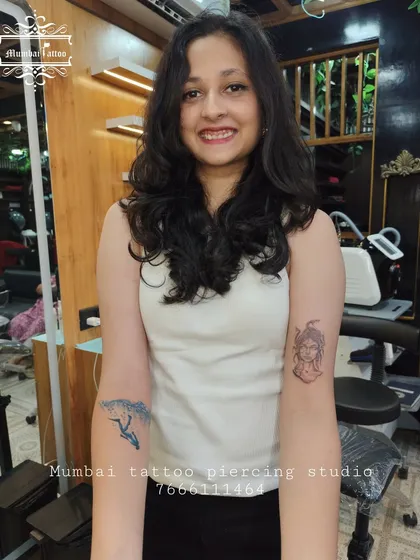 This client got two tattoos in one session: a powerful Medusa head and a dynamic surfing wave. It shows our versatility in handling different styles, from mythology to nature.