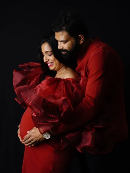 An intimate couple's portrait in our red Ruth gown. The rich organza fabric and deep red color create a warm and romantic mood.