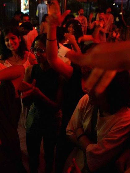 The crowd under red lights at our Social Sunday Sundowner, lost in the music and energy of the night.