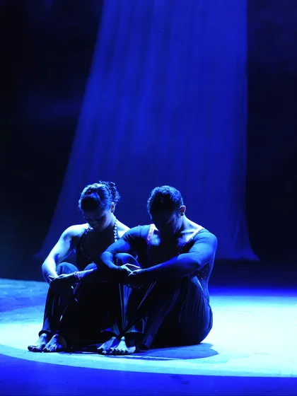 A quiet, powerful moment before the music swells. This photo captures the dramatic storytelling aspect of our performances, using lighting and posture to create a mood on stage.