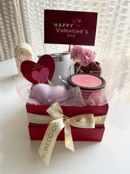 A compact and cute Valentine's gift box for him or her, with a tumbler, a heart-shaped candle, and a body scrub.