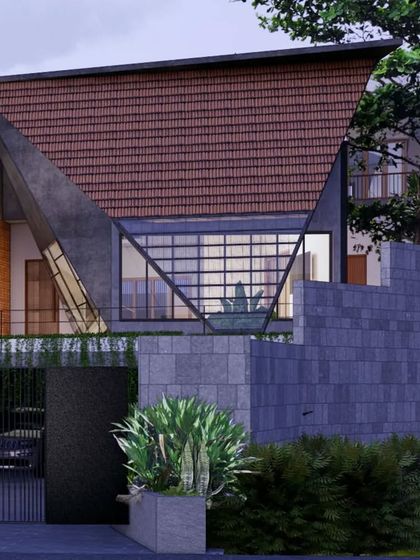A striking feature of the Hegde Residence is its large, triangulated roof form, which creates a dramatic entryway. This design uses locally sourced Mangalore tiles and glass, blending traditional materials with a bold, contemporary architectural statement.
