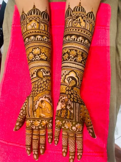 This elegant design features portraits of the couple during a wedding ritual. The arms are adorned with majestic peacocks and palace motifs, with the couple's initials on top.