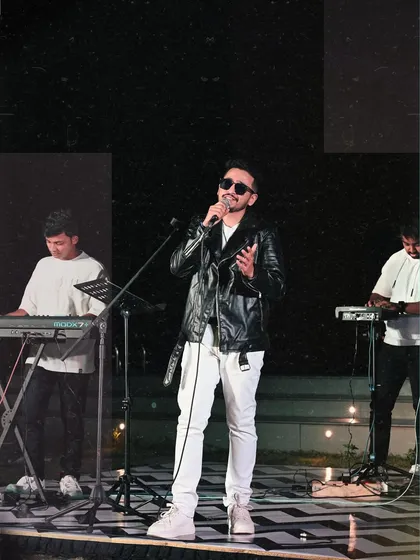 This is me in my element, on stage with my band, feeling the music. Dressed in all black with sunglasses on, ready to deliver a powerful performance. This is where I feel most alive.